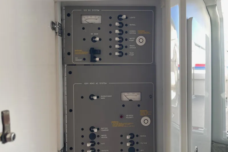 Slide: The Image of Control panel of a 2004 Formula 382 FASTech boat, featuring 12V DC and 120V AC systems. - 57
