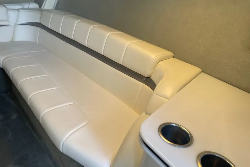 Slide: The Image of Interior of 2004 Formula 382 FASTech boat with beige seating and cup holders. - 58