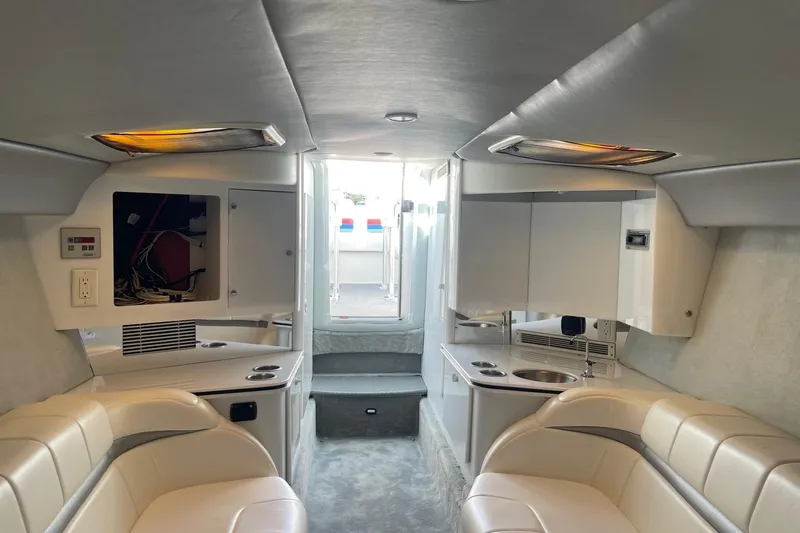 Slide: The Image of 2004 Formula 382 FASTech boat interior with white seating and compact kitchenette. - 60