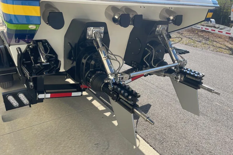 Slide: The Image of Rear view of a 2004 Formula 382 FASTech boat with dual outdrives and colorful hull design. - 8