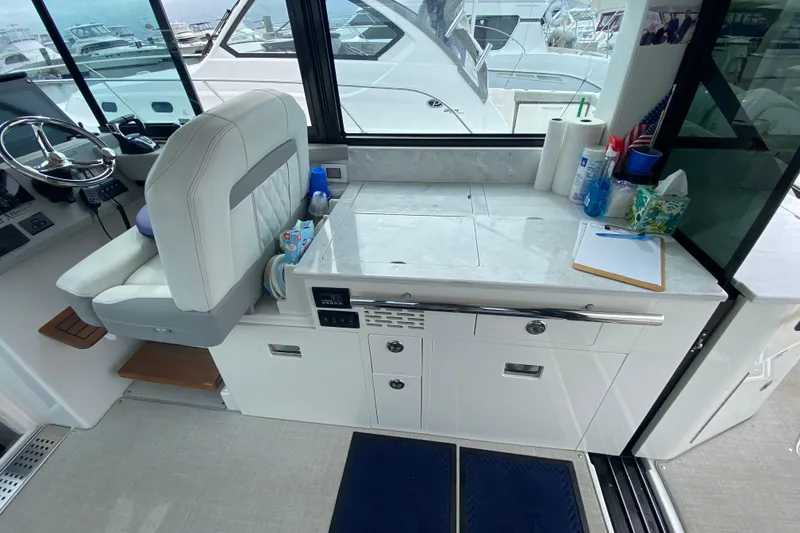 Slide: The Image of Interior of 2022 Regal 36 XO yacht with seating, helm, and countertop. - 11
