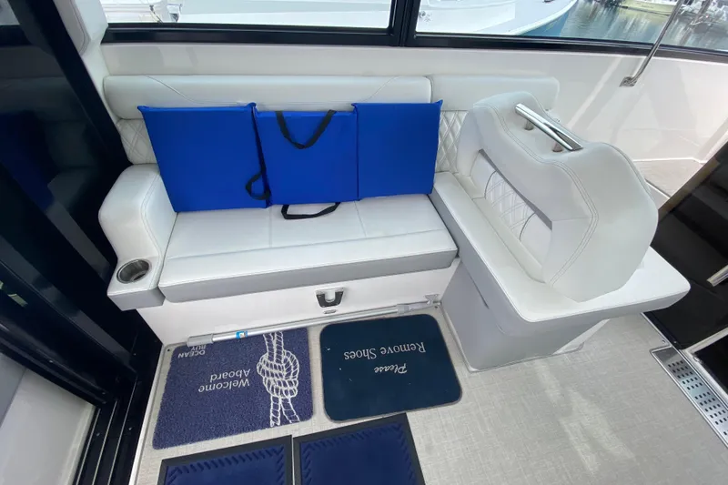 Slide: The Image of 2022 Regal 36 XO yacht interior with helm, countertop, and storage cabinets. - 12