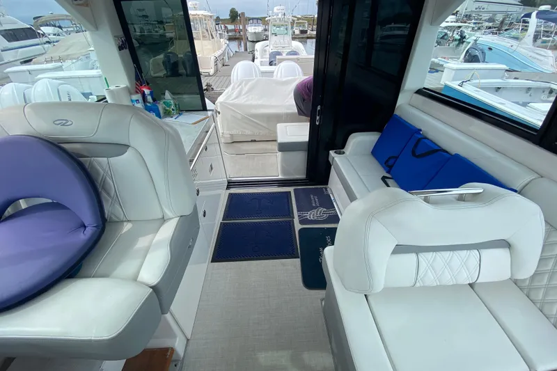 Slide: The Image of Interior of 2022 Regal 36 XO boat with luxurious white seating and modern design. - 14