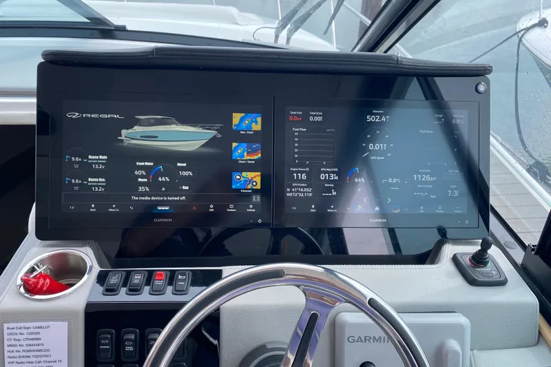 Slide: The Image of 2022 Regal 36 XO boat helm with Garmin navigation and controls. - 16