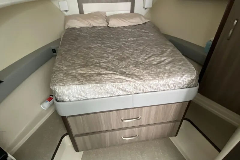 Slide: The Image of 2022 Regal 36 XO cabin interior with bed and storage drawers. - 20