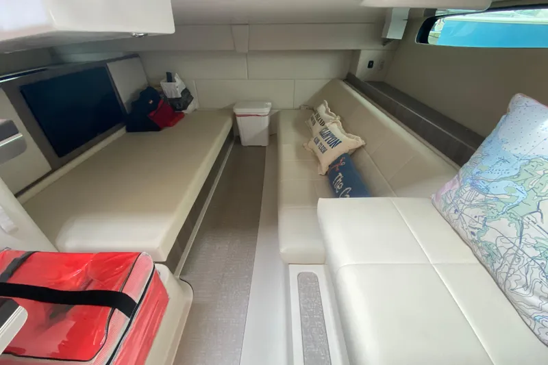 Slide: The Image of Interior of 2022 Regal 36 XO yacht with cozy seating and nautical decor. - 22