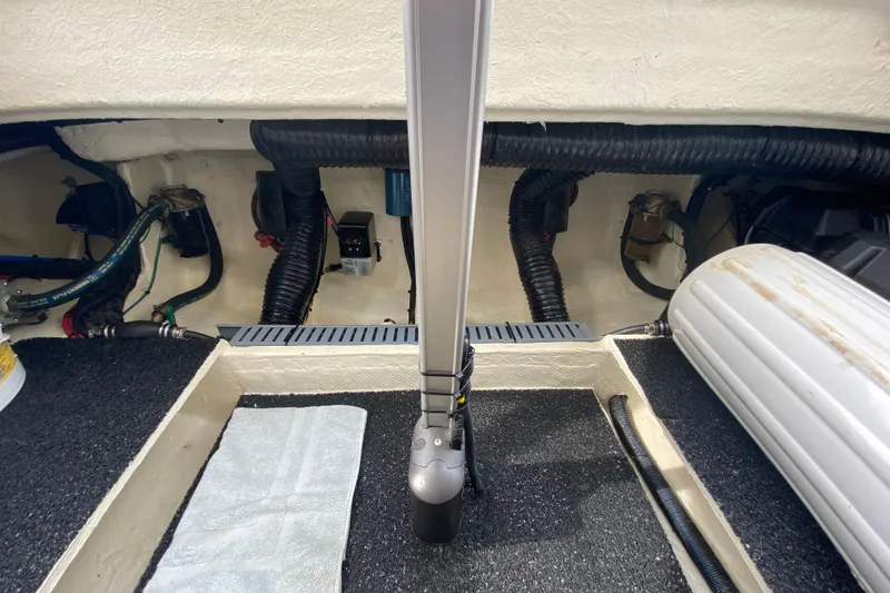 Slide: The Image of Engine compartment of 2022 Regal 36 XO boat, showcasing mechanical components and storage. - 25