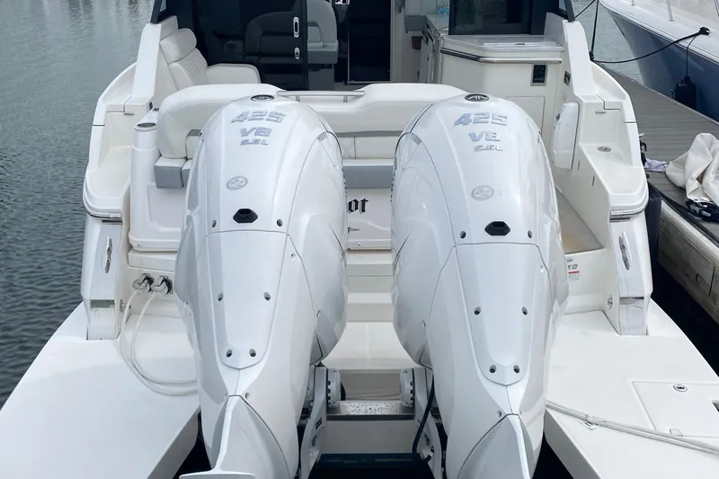 Slide: The Image of 2022 Regal 36 XO yacht docked, featuring Yamaha outboard engines and sleek design. - 3