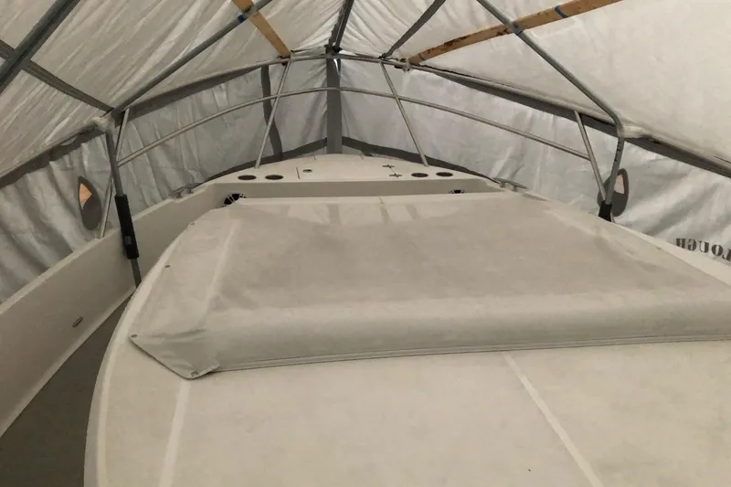 Slide: The Image of Covered 2022 Regal 36 XO boat in storage, surrounded by other boats. - 30