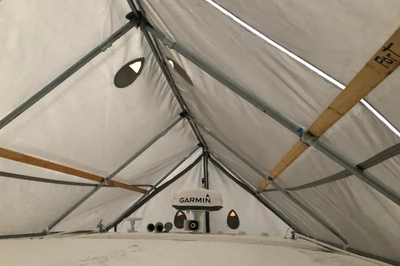 Slide: The Image of 2022 Regal 36 XO boat under protective cover in storage. - 31