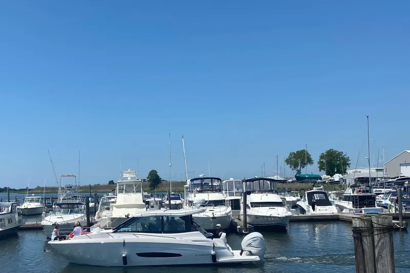 Slide: The Image of Covered 2022 Regal 36 XO boat with Garmin equipment under protective shelter. - 32