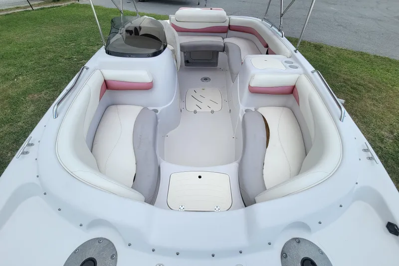 Slide: The Image of 2008 Tahoe 195 I/O boat interior with white and pink seating, parked on grass. - 10