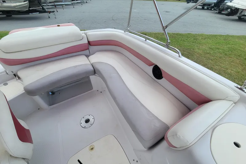 Slide: The Image of 2008 Tahoe 195 I/O boat interior with white and pink seating, docked outdoors. - 11