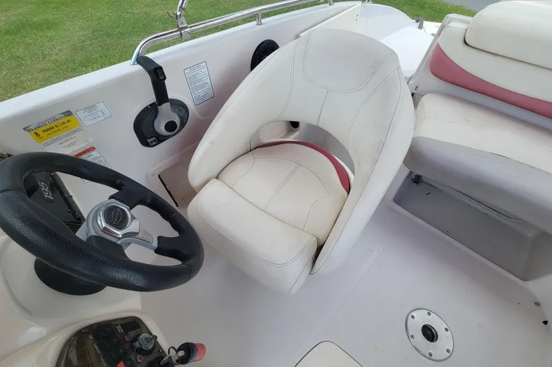 Slide: The Image of 2008 Tahoe 195 I/O boat interior with steering wheel and white seating. - 12