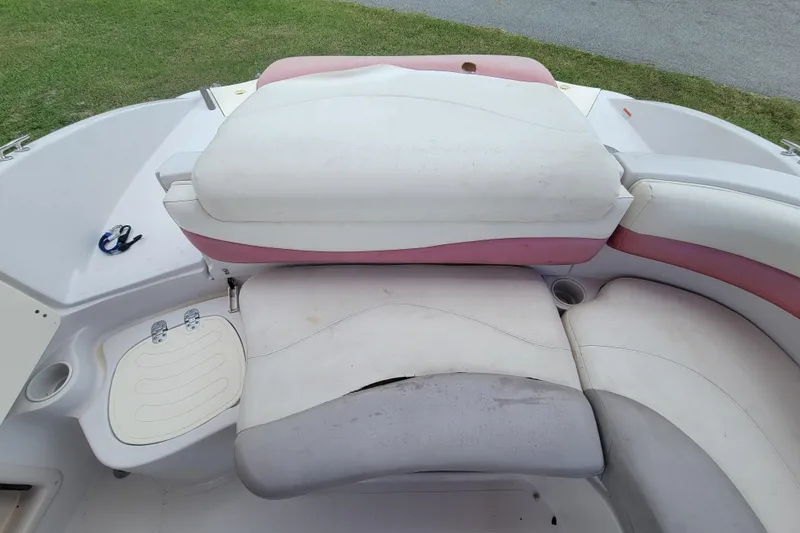 Slide: The Image of 2008 Tahoe 195 I/O boat interior with white and pink seating, cup holders, and storage compartment. - 13