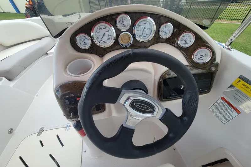 Slide: The Image of Steering wheel and dashboard of a 2008 Tahoe 195 I/O boat with gauges and controls. - 15