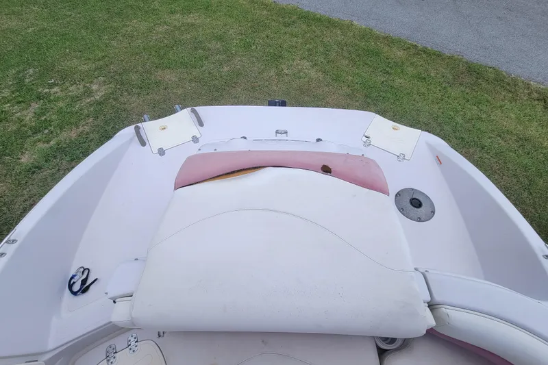Slide: The Image of 2008 Tahoe 195 I/O boat interior with seating and storage compartments on grass. - 16