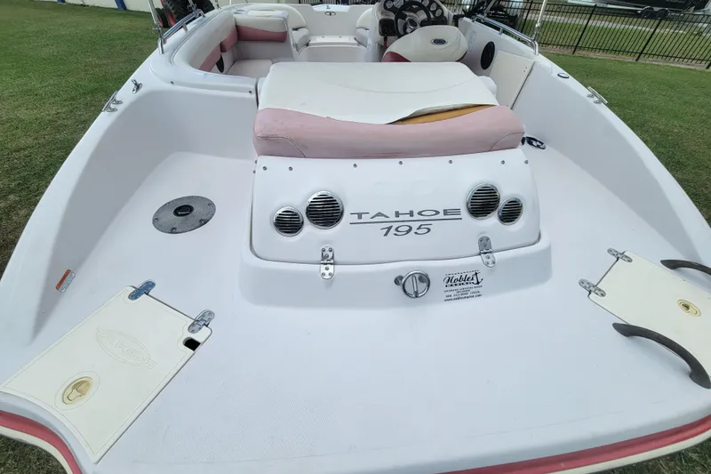 Slide: The Image of 2008 Tahoe 195 I/O boat interior with seating and dashboard, displayed on grass. - 17