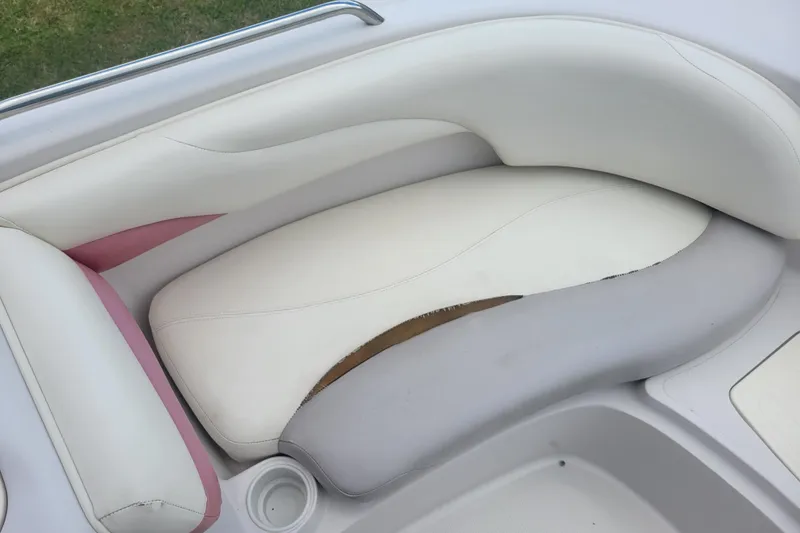 Slide: The Image of 2008 Tahoe 195 I/O boat seat with white and pink upholstery, slight wear visible. - 7