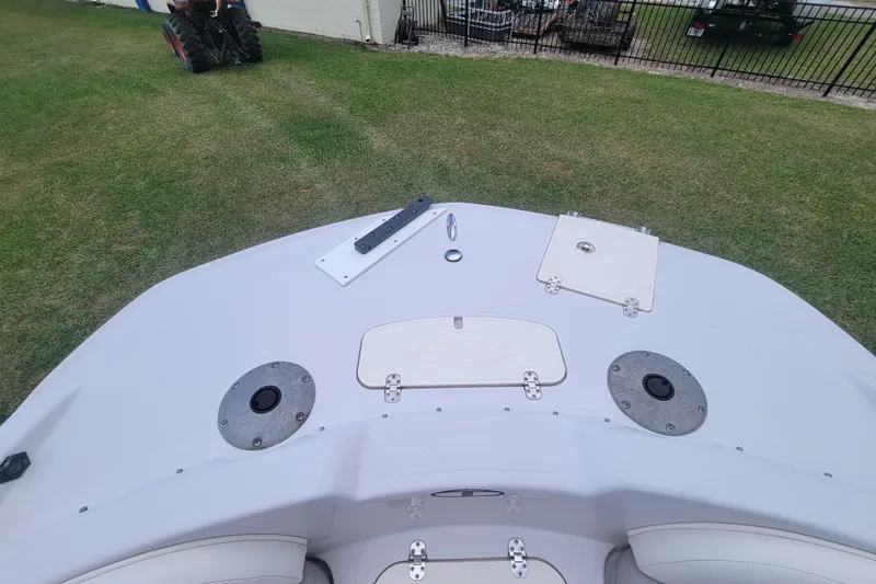 Slide: The Image of 2008 Tahoe 195 I/O boat bow on grass, featuring storage compartments and seating. - 9