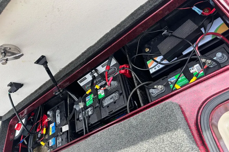 Slide: The Image of 2015 Ranger Z119 Comanche boat battery compartment with multiple batteries and wiring. - 16