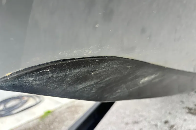 Slide: The Image of Close-up of a 2015 Ranger Z119 Comanche boat hull with visible wear. - 2