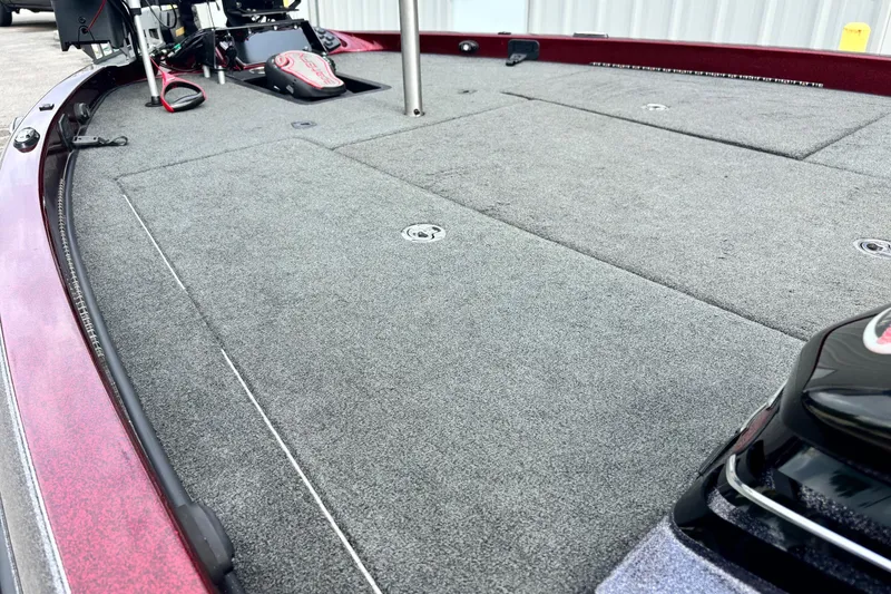 Slide: The Image of 2015 Ranger Z119 Comanche boat deck with gray carpet and fishing equipment. - 5