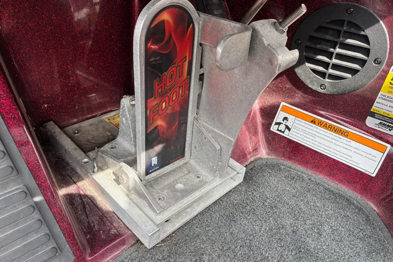 Slide: The Image of 2015 Ranger Z119 Comanche boat foot throttle labeled "Hot Foot" with warning label. - 7