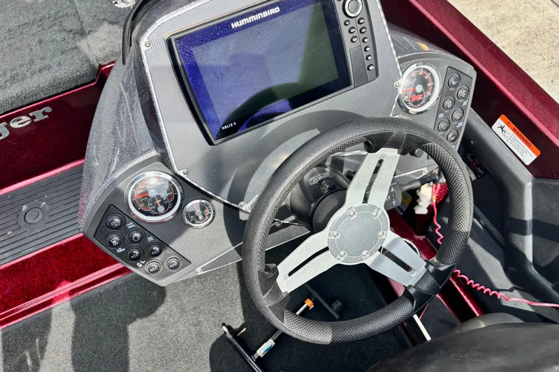 Slide: The Image of 2015 Ranger Z119 Comanche boat dashboard with steering wheel and Humminbird Helix 9 display. - 8