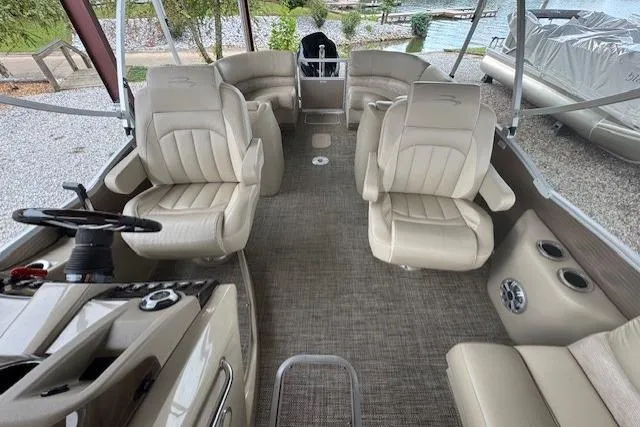 Slide: The Image of 2015 Bennington 2350 RSR boat interior with beige seating and steering console. - 11