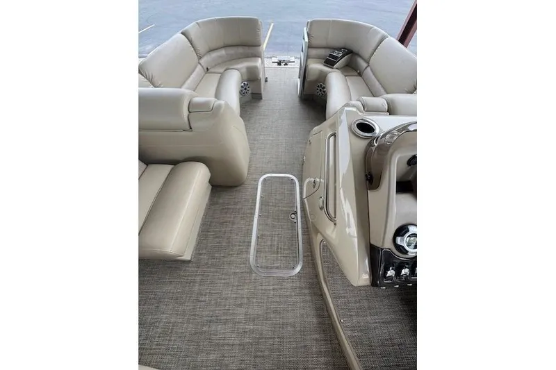 Slide: The Image of 2015 Bennington 2350 RSR pontoon boat interior with beige seating and control panel. - 15