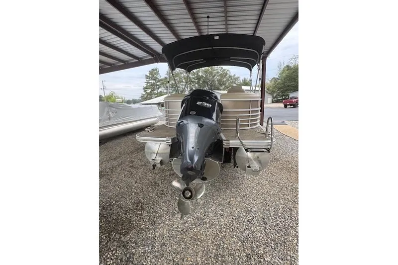 Slide: The Image of 2015 Bennington 2350 RSR pontoon boat with outboard motor under a metal canopy. - 7