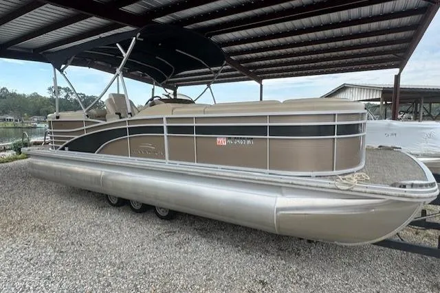 Slide: The Image of 2015 Bennington 2350 RSR pontoon boat under a metal canopy. - 8