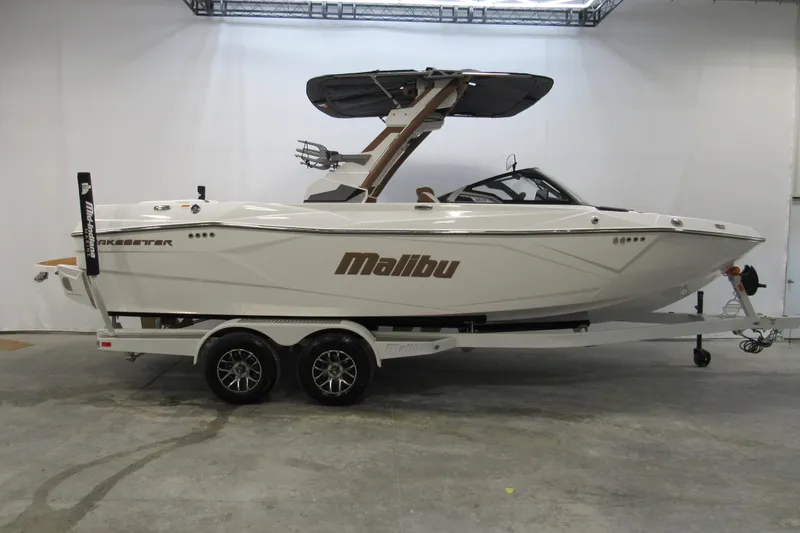 The Image of 2026 Malibu Wakesetter 23 LSV boat on trailer in indoor showroom. - 0