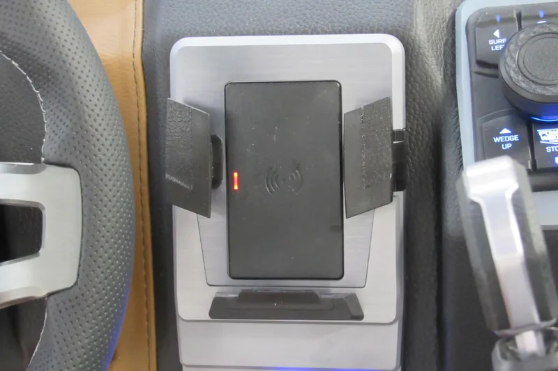 Slide: The Image of 2026 Malibu Wakesetter 23 LSV dashboard with wireless charging pad and control panel. - 11