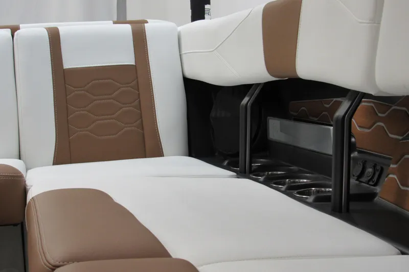Slide: The Image of 2026 Malibu Wakesetter 23 LSV interior with brown and white seating, cup holders visible. - 12