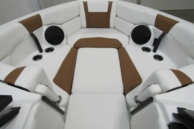 Slide: The Image of 2026 Malibu Wakesetter 23 LSV interior with white and brown seating, cup holders, and speakers. - 13