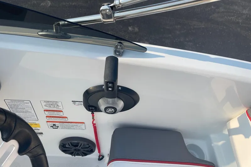 Slide: The Image of 2021 Tahoe T-16 boat control panel with throttle lever and safety features. - 12