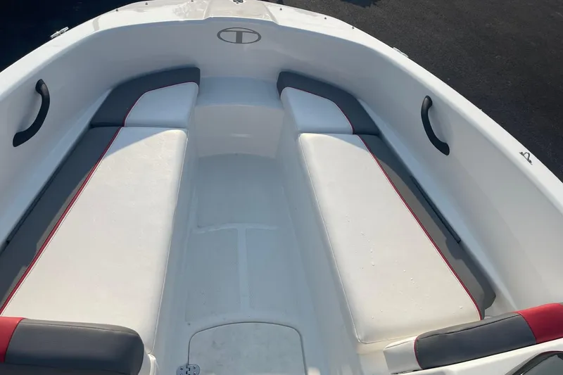 Slide: The Image of 2021 Tahoe T-16 boat interior with white and gray seating, red accents. - 15