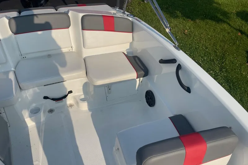 Slide: The Image of Interior of 2021 Tahoe T-16 boat with gray and red seating, cup holders, and speaker. - 19