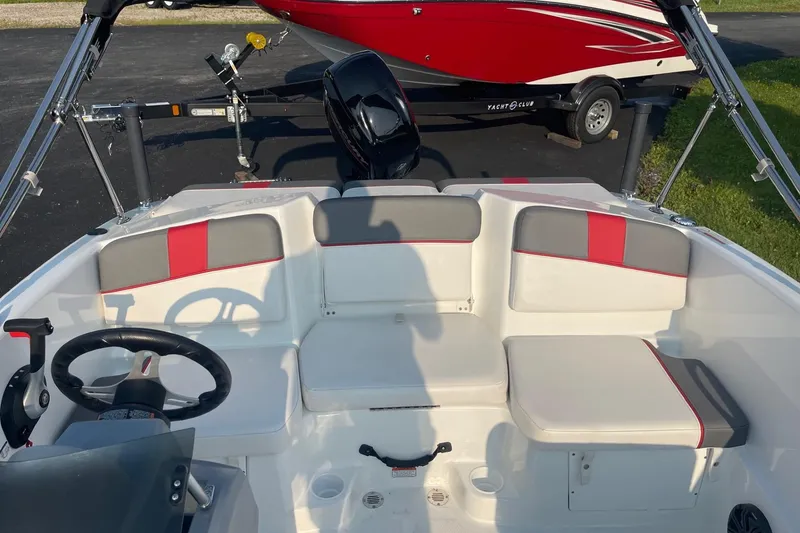 Slide: The Image of 2021 Tahoe T-16 boat interior with red and gray seating, steering wheel, and controls. - 21