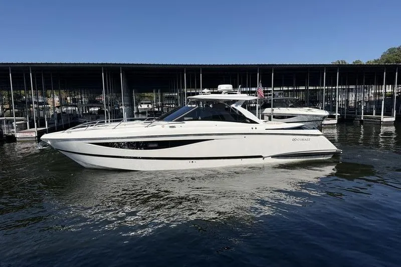 The Image of 2015 Cobalt A40 boat docked on calm water under clear blue sky. - 0