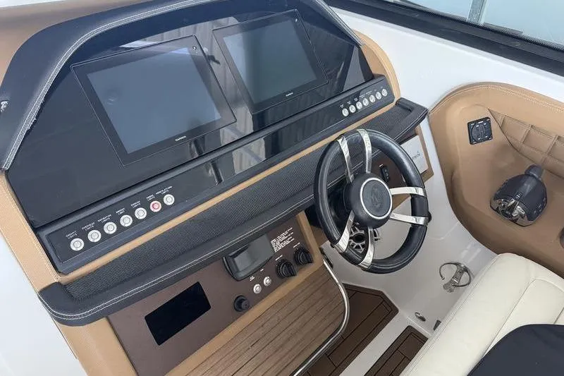 Slide: The Image of Dashboard of a 2015 Cobalt A40 boat with dual screens and steering wheel. - 10