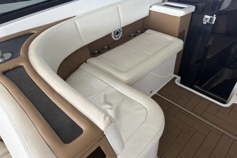 Slide: The Image of Luxurious seating area on 2015 Cobalt A40 boat with white and tan upholstery. - 13