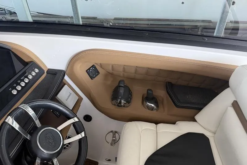 Slide: The Image of Interior of a 2015 Cobalt A40 boat, featuring steering wheel and control panel. - 18