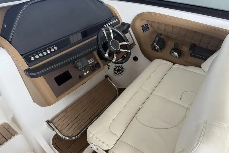 Slide: The Image of 2015 Cobalt A40 boat helm with beige seating, modern controls, and wooden accents. - 19