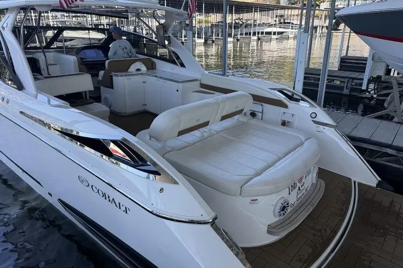 Slide: The Image of 2015 Cobalt A40 luxury boat docked, featuring spacious seating and sleek design. - 3