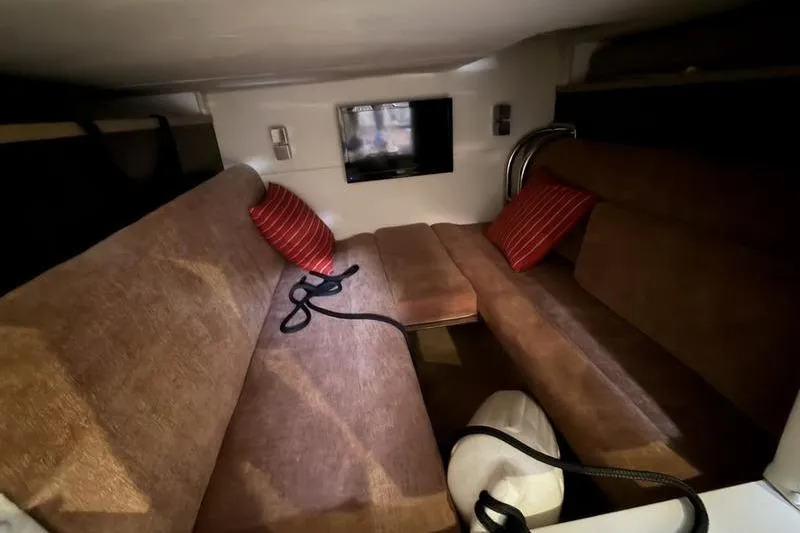 Slide: The Image of Interior cabin of 2015 Cobalt A40 boat with brown seating and red pillows. - 4