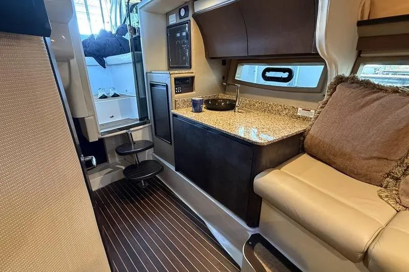Slide: The Image of Luxurious interior of a 2015 Cobalt A40 yacht with kitchenette and seating area. - 5