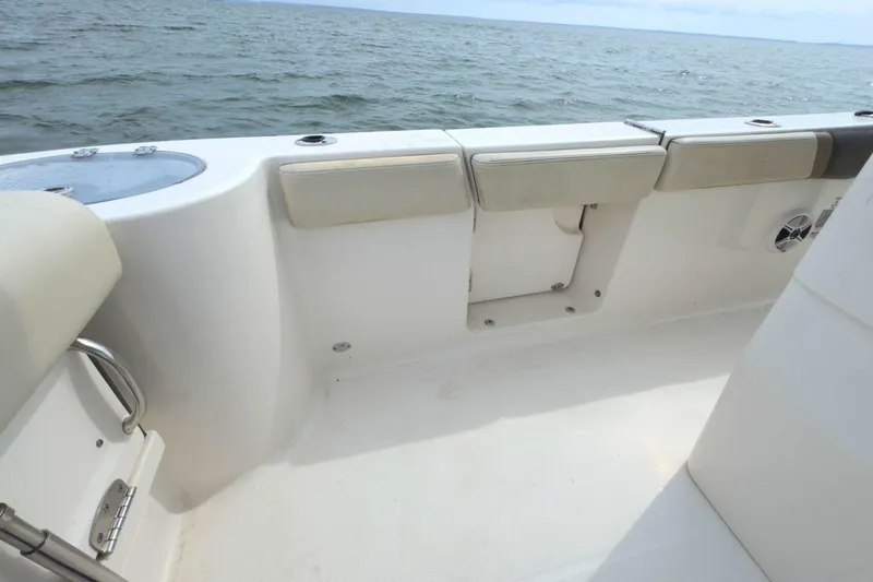 Slide: The Image of 2019 Robalo R272 Center Console boat interior with cushioned seating and ocean view. - 12
